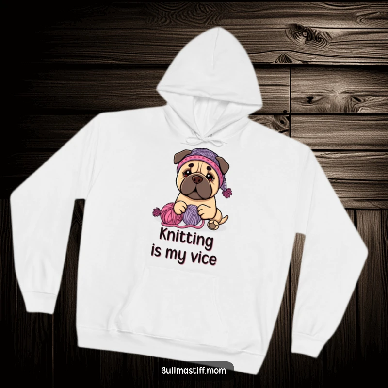 Funny Bullmastiff dog wearing a knit hat, happily playing with yarn, on a warm hoodie, a great funny gift.