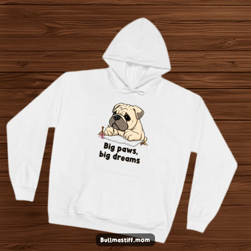 Funny Bullmastiff with large, clumsy paws attempting embroidery, depicted on a comfortable hoodie, perfect for cozy crafting sessions.