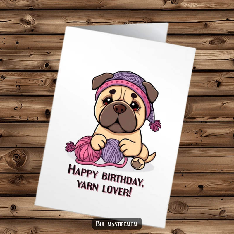 Funny Free Printable Birthday Card: Bullmastiff in knit hat playfully tangles with colorful yarn.